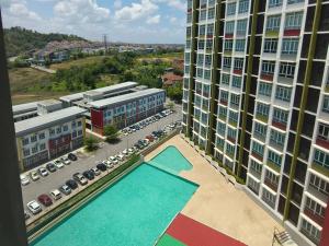 an aerial view of a pool in the middle of a building at LV13 PoolView Kuantan by Vhomestay in Kuantan