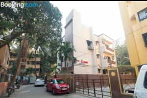 a red car parked on a city street with buildings at Hotel classic residency in Mumbai