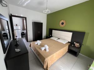 ein Schlafzimmer mit einem Bett mit zwei Handtüchern darauf in der Unterkunft Villa Antonis deluxe apartments in Ammoudi