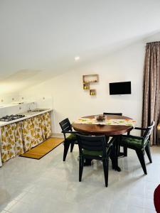 a kitchen and dining room with a table and chairs at La Mansarda di Terelle in Terelle