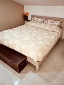 a large bed in a bedroom with a wooden drawer at La Mansarda di Terelle in Terelle +14 photos