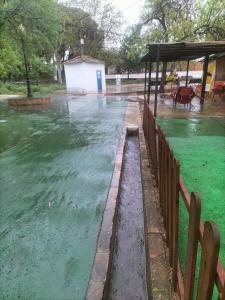 a pool of water next to a wooden fence at Casa Rural Valle de los Molinos in El Cristo del Espíritu Santo