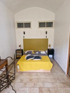 - une chambre avec un lit jaune et 2 serviettes dans l'établissement Appartement centre Saint Florent, à Saint-Florent