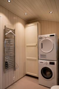 a laundry room with a washing machine and a washer at Klara House in Isfjorden