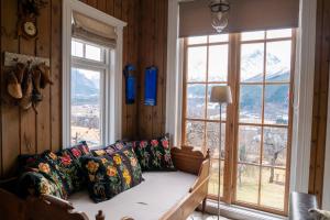 a living room with a couch in front of a window at Klara House in Isfjorden