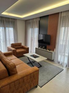 a living room with a couch and a flat screen tv at Apartman ANNA ATINA Budva in Budva