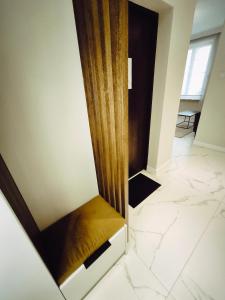 a walk in shower in a room with marble floors at Central Apartments Ogarna 5 in Gdańsk