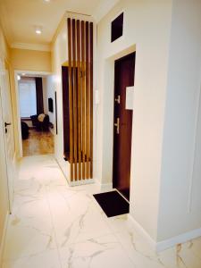 a hallway with a door and a floor of marble at Central Apartments Ogarna 5 in Gdańsk
