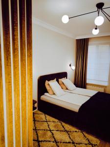 a bedroom with a bed and a window at Central Apartments Ogarna 5 in Gdańsk