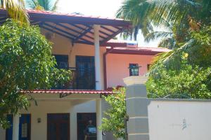 a house with a balcony on top of it at Lighthouse Villa Koggala in Galle