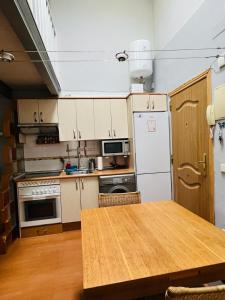 a kitchen with a table and a white refrigerator at Palafox in Madrid