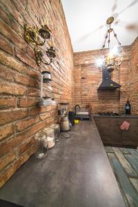 a kitchen with a brick wall and a counter at Loft Style Apartment in Tbilisi City