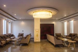 a waiting room with chairs and a chandelier at Hotel Dekiling by Ladakh lodge Group in Leh