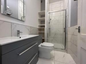 a bathroom with a toilet and a sink and a shower at Howburn Place in Aberdeen