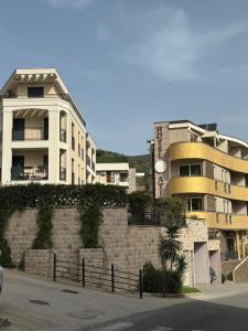 a building and a wall in front of a building at Apartman ANNA ATINA Budva in Budva