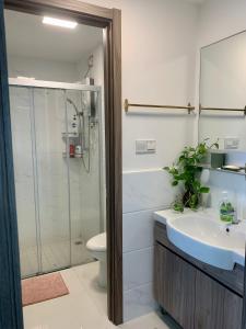 a bathroom with a shower and a sink and a toilet at Sea view 2 bedroom Fully furnished Apartment Forest City Starview Bay Johor Malaysia in Kampong Pok Kechil