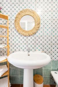 a bathroom with a white sink and a mirror at BOHEMIAN - Taormina Central Apartment in Taormina
