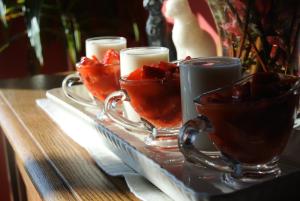 a tray with two tea cups and candles on a table at Hotel Rural El Algaire in Arquera de Salas +35 photos