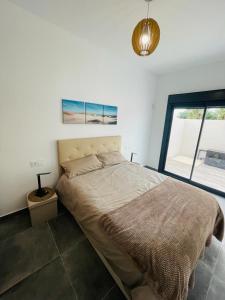 a bedroom with a bed and a large window at Casa XtelBen in Daya Nueva