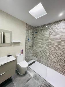 a bathroom with a toilet and a glass shower at Casa XtelBen in Daya Nueva