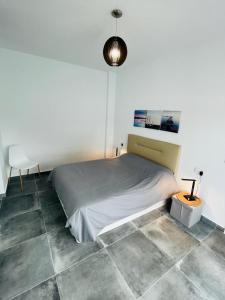 a bedroom with a bed and a lamp and tiled floor at Casa XtelBen in Daya Nueva +11 photos