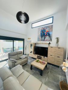 a living room with a couch and a flat screen tv at Casa XtelBen in Daya Nueva