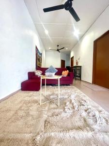 a living room with a couch and a table at Cozy 255 Entire 3 Bedroom House At Alma Bukit Mertajam in Bukit Mertajam