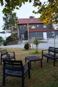 a group of benches in front of a building at Casal Do Crego in O Grove