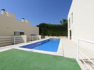 a swimming pool in the backyard of a house at Luxury Holiday Home Albufeira in Albufeira
