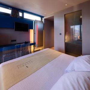Postel nebo postele na pokoji v ubytování Essence Hotel