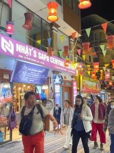 a group of people walking in a shopping mall at Nhật's Sapa Central Hostel in Sa Pa