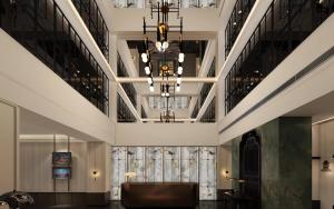 a large lobby with a large chandelier and a bench at JingLai Bushe Hotel Bund Nanjing West Road Shanghai in Shanghai