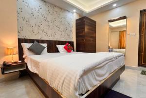 a bedroom with a large bed in a room at Hotel Aradhya Puri Sea View Room - Luxury Stay - Best Hotel in Puri in Puri