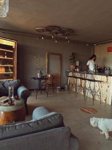 a living room with a man standing at a bar at Quonset Glamping in Seferihisar