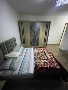 a large bed in a room with a painting on the wall at CAI-Transit Sleep and Free 2-Ways-taxi in Cairo