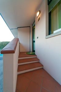 a hallway of a building with stairs and a window at Dealuna Motel in Fidenza