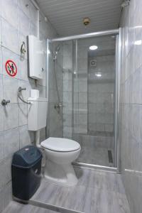 a bathroom with a toilet and a glass shower at Hostel Best Skopje in Skopje