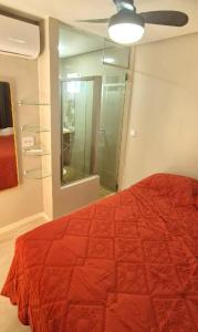 Schlafzimmer mit einem roten Bett und einem Spiegel in der Unterkunft Salt Beach Residence Inn in Salinópolis