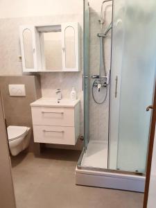 a bathroom with a shower and a sink and a toilet at Guesthouse Pejo in Poreč