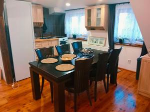 a kitchen with a dining room table and chairs at Penzion Václav in Hnojní