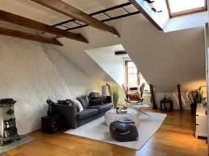 a living room with a couch and a table at Spacious Penthouse close to center in Stockholm