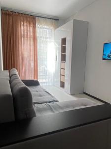 a large bed in a room with a window at Одесса Калипсо у Моря на Пляже-однокомнатные апартаменты 24 метра in Odesa +62 photos