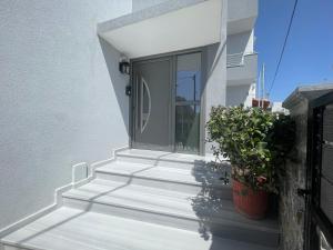 a front door of a house with stairs and a plant at The skyline escape in Heraklio