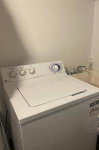 a white stove top oven sitting next to a sink at Pembroke suites in Toronto