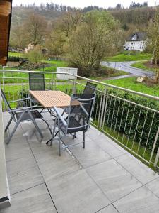 a wooden table and two chairs on a balcony at Haus Kleeblatt in Cochem