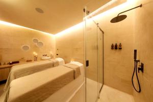 a bathroom with a shower and a toilet and a sink at Casa Nostra Boutique Hotel & Spa in Palermo