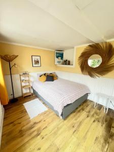 a bedroom with a large bed and a mirror at Maisonnette avec escalier in Menton