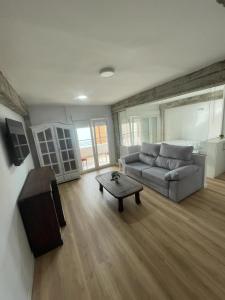 a living room with a couch and a coffee table at Monte y mar Albufereta in Alicante