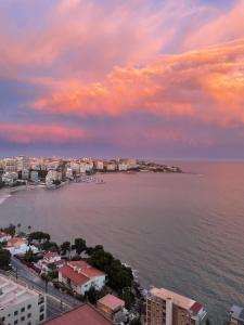 a view of a city and the ocean at sunset at Monte y mar Albufereta in Alicante