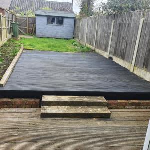 a wooden walkway in a backyard with a fence at Beautiful and Cozy 2 Bedroom Apartment Billericay in Billericay